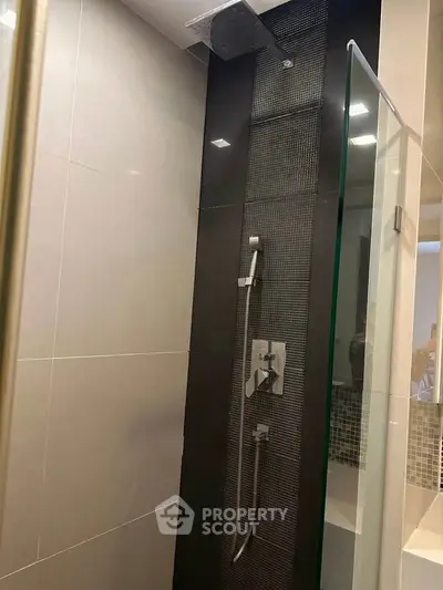 Modern bathroom shower with sleek design and glass door in contemporary home.