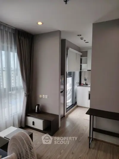 Modern apartment interior with open layout and large window view
