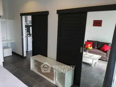 Modern living room with sliding doors and stylish furniture in a contemporary apartment.