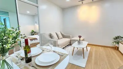 Modern living room with cozy sofa and dining area in stylish apartment