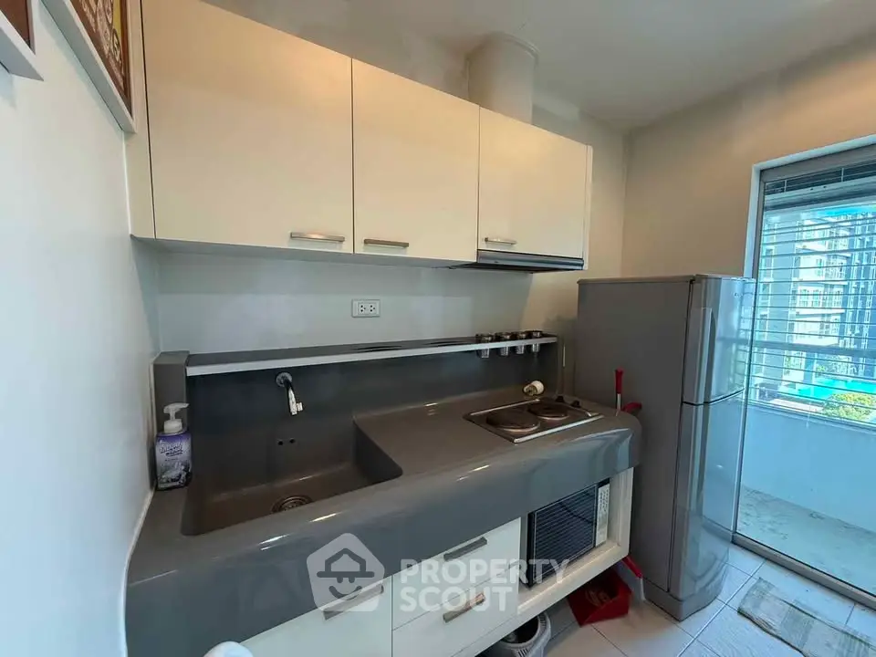 Modern kitchen with sleek cabinetry and compact design in urban apartment