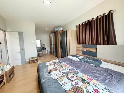 Spacious bedroom with modern decor and ample natural light