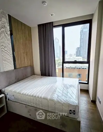 Modern bedroom with city view and stylish decor in high-rise apartment