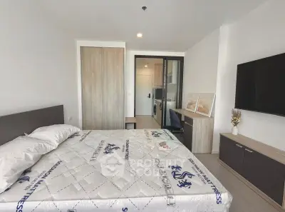 Modern bedroom with stylish decor and in-unit laundry, perfect for urban living.