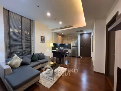 Modern open-plan living room with stylish kitchen and cozy seating area.