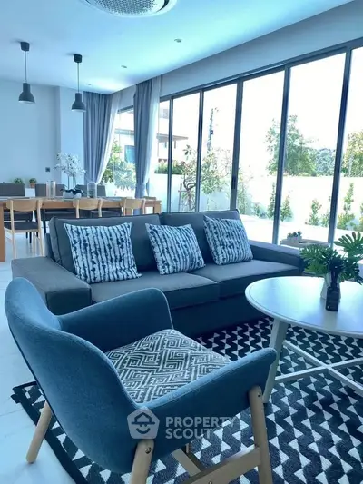 Modern living room with large windows and stylish furniture