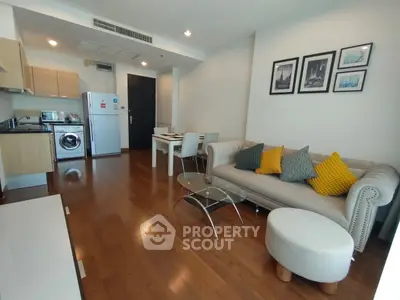 Modern living room with stylish furniture and open kitchen layout in a cozy apartment.