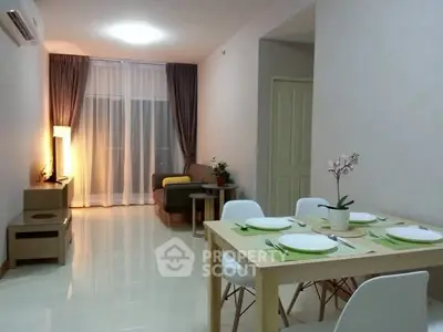 Modern living room with dining area, featuring sleek furniture and ambient lighting for a cozy atmosphere.