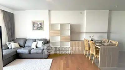 Modern living room with cozy sofa and dining area in open layout apartment