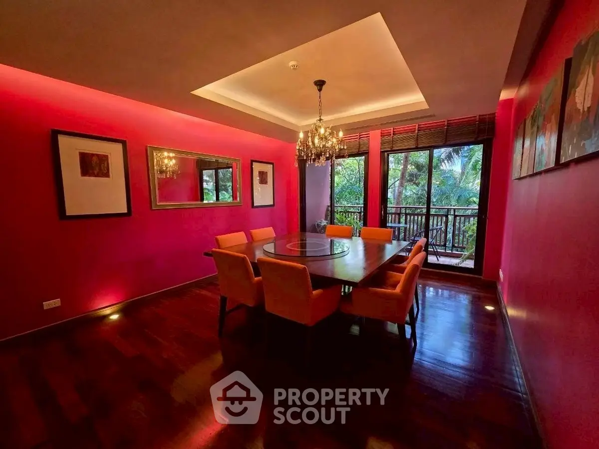 Luxurious dining room with vibrant pink walls and elegant chandelier