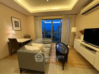 Modern living room with city view, featuring stylish furniture and ambient lighting.
