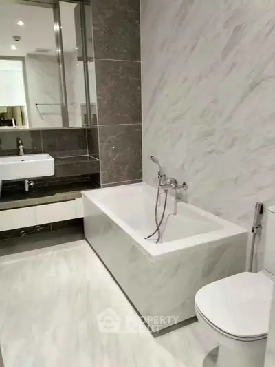 Modern bathroom with sleek design featuring a bathtub and elegant fixtures.