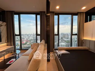 Luxurious high-rise apartment with stunning city skyline views from the living room and bedroom.