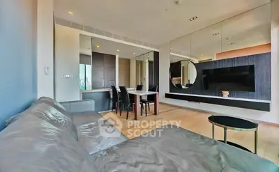 Modern living room with sleek design, leather sofa, and wall-mounted TV in a stylish apartment.