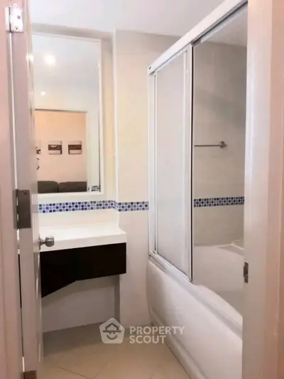 Modern bathroom with sleek design and bathtub in a stylish apartment.