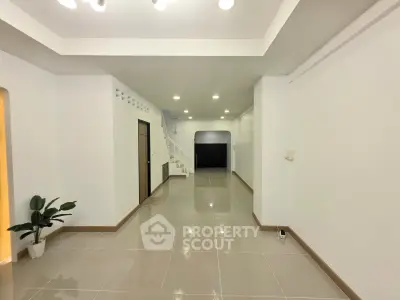 Spacious modern interior with sleek tile flooring and minimalist design, perfect for versatile living arrangements.