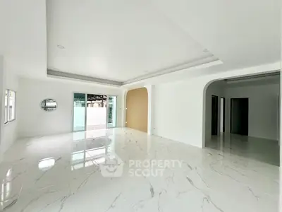 Spacious modern living room with marble flooring and large windows