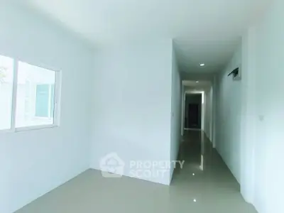 Bright hallway with glossy floors and modern design in a minimalist home.