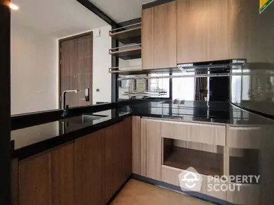 Modern kitchen with sleek wooden cabinetry and black countertops