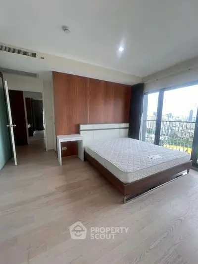 Spacious bedroom with city view and modern wooden flooring