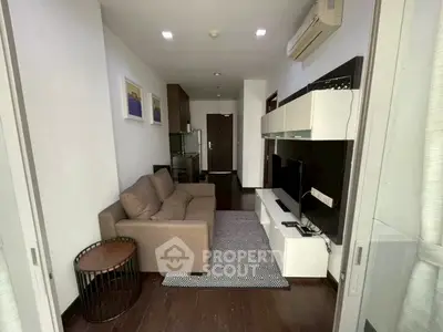 Modern living room with sleek furniture and air conditioning in a stylish apartment.