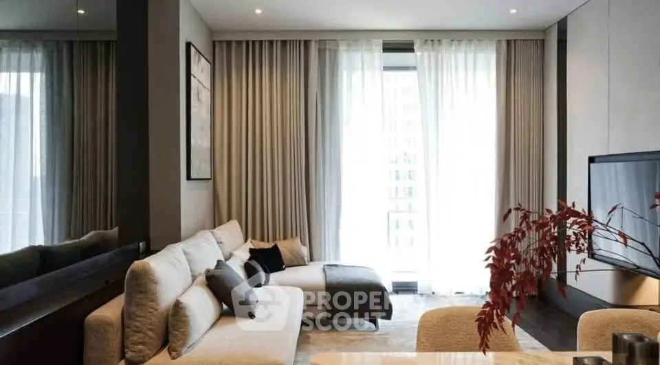 Modern living room with elegant decor and large windows for natural light.