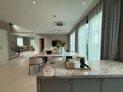 Luxurious open-plan living room with elegant dining area and modern decor