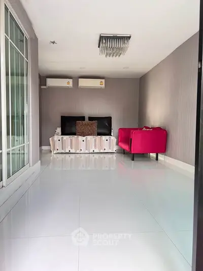 Modern living room with sleek design and vibrant red sofa