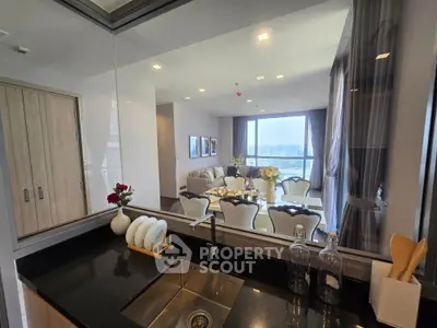 Luxurious open-layout kitchen with elegant dining area and stunning city view, perfect for modern living.