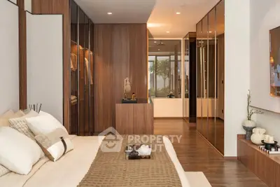 Luxurious bedroom with elegant wooden accents and spacious walk-in closet, perfect for modern living.