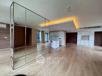 Spacious modern living room with open kitchen and elegant wood flooring