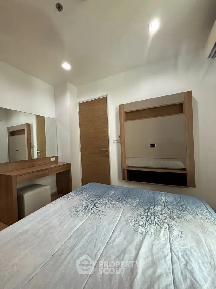Cozy bedroom with modern wooden furniture and stylish decor, perfect for relaxation and comfort.