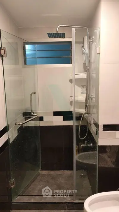 Modern bathroom with glass shower enclosure and sleek fixtures