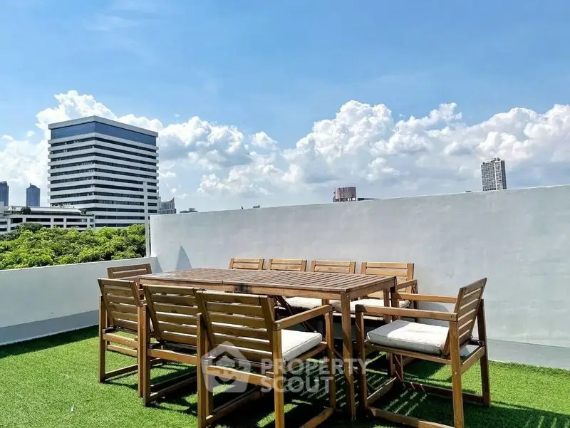 Stunning rooftop terrace with outdoor seating and city skyline views.