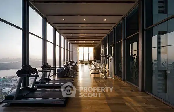 Luxurious high-rise gym with panoramic city views and modern fitness equipment.