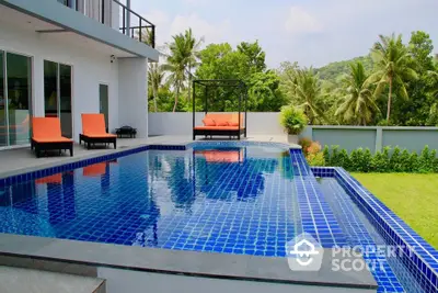 Luxurious modern villa with stunning infinity pool and lush tropical garden view.