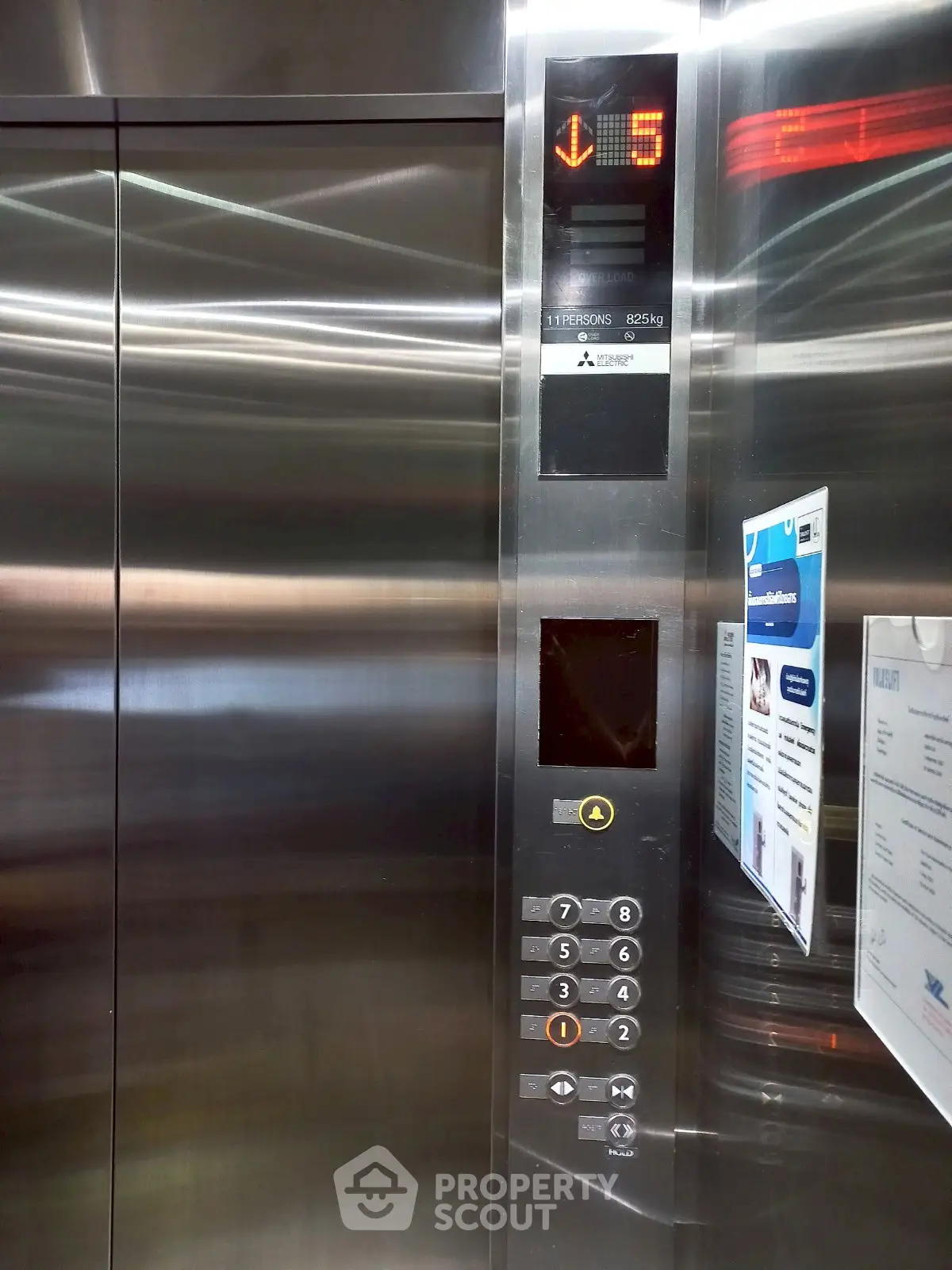 Modern elevator interior with stainless steel finish and digital display