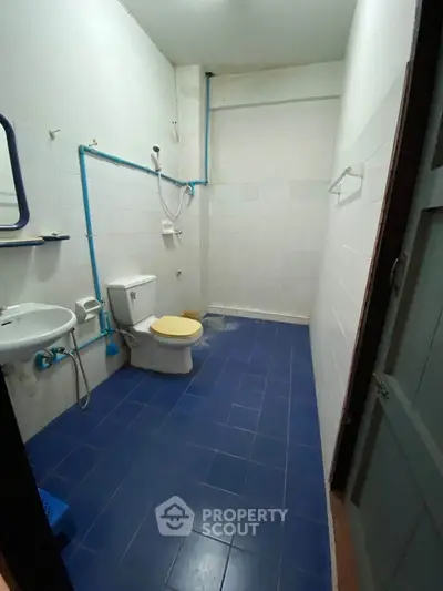 Spacious bathroom with blue tiled floor and modern fixtures