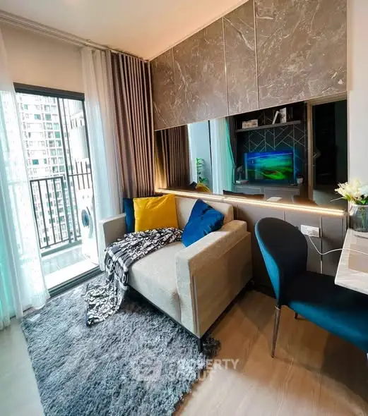 Modern living room with cozy seating and balcony view in urban apartment