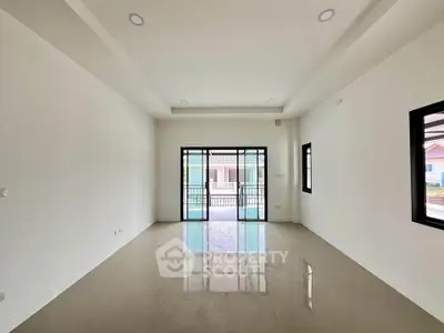 Spacious empty living room with large windows and glossy tiled floor, perfect for customization.