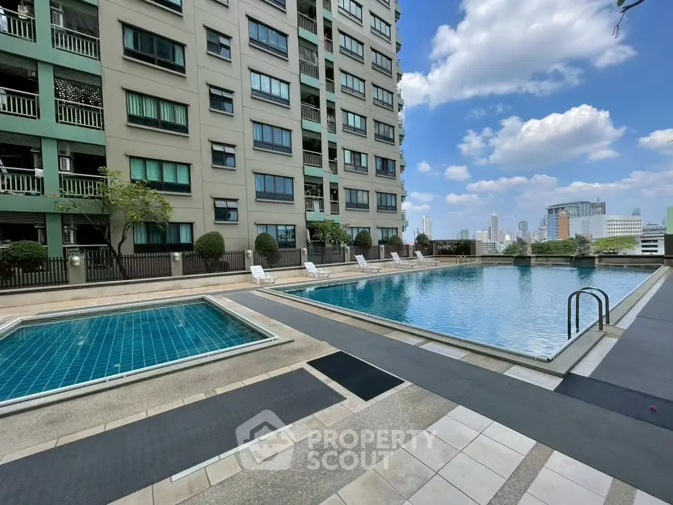 Luxurious condominium with rooftop pool offering stunning city views and modern amenities.