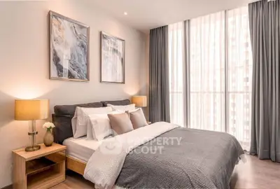 Elegant bedroom with modern decor and large windows for natural light.