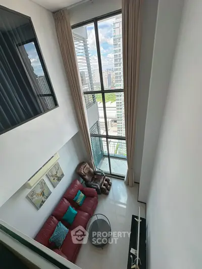 Stunning high-ceiling living room with large windows and city view