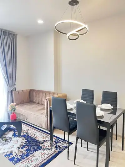 Modern living room with elegant dining area and stylish lighting