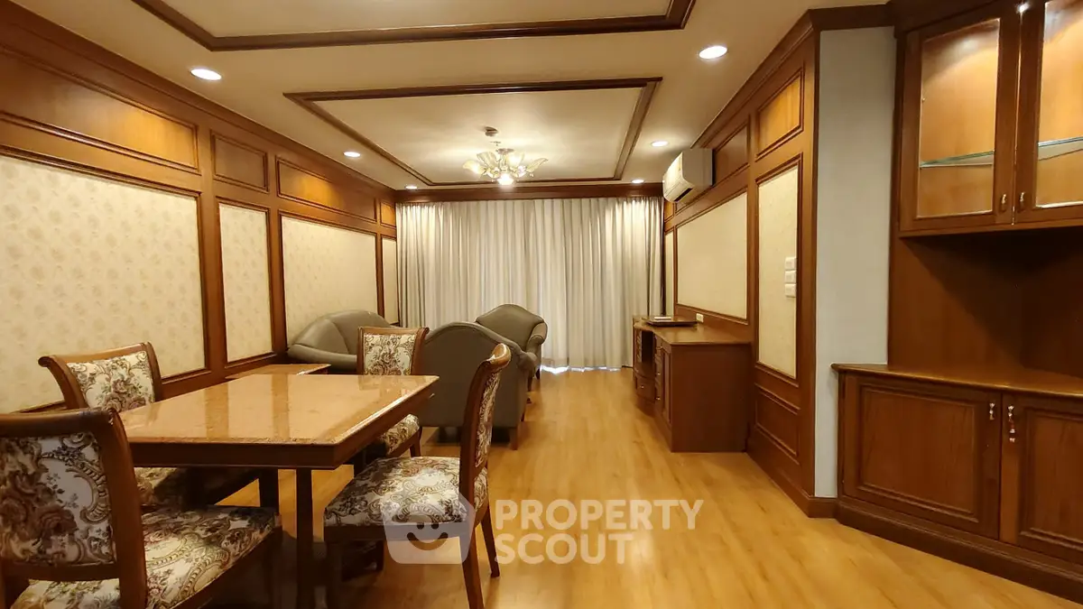 Luxurious living room with elegant wood paneling and plush seating in a high-end apartment.