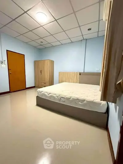 Spacious bedroom with modern furnishings and ample natural light, perfect for comfortable living.