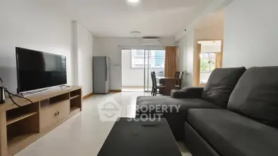 Spacious living room with modern furniture and natural light, perfect for relaxation and entertainment.