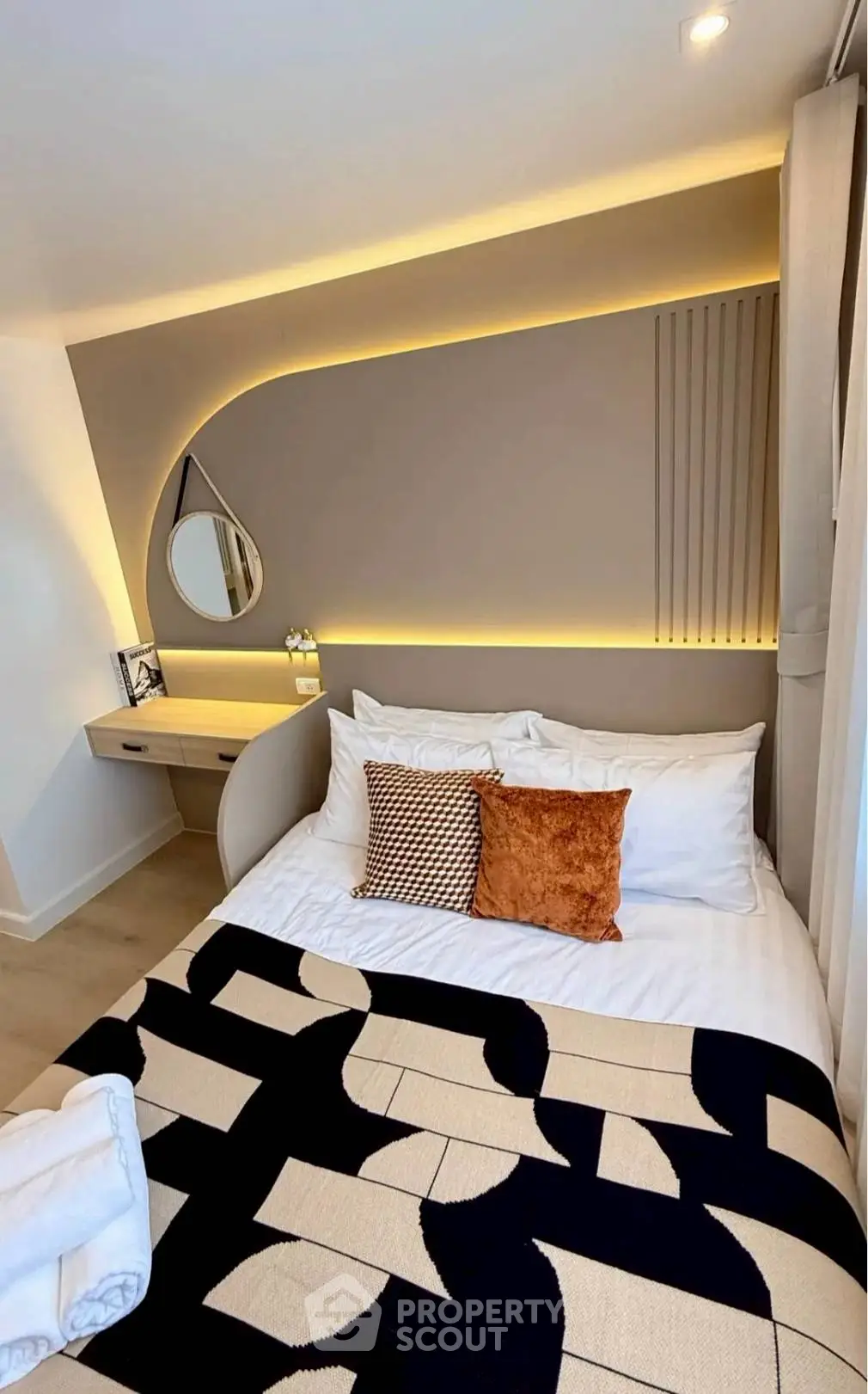 Modern bedroom with stylish lighting and cozy decor, perfect for relaxation and comfort.