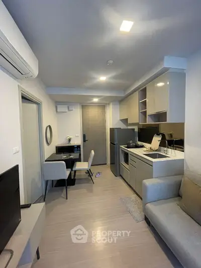 Modern compact living room with open kitchen and stylish furniture