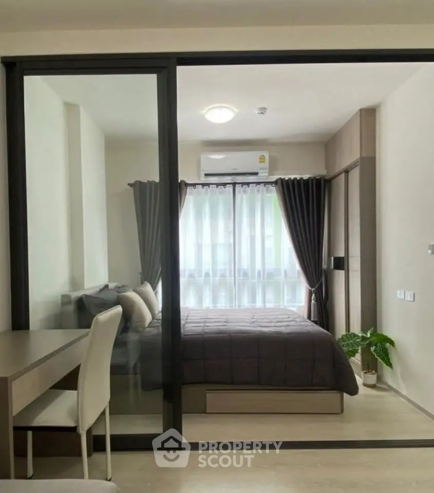 Modern bedroom with glass partition and cozy decor in urban apartment